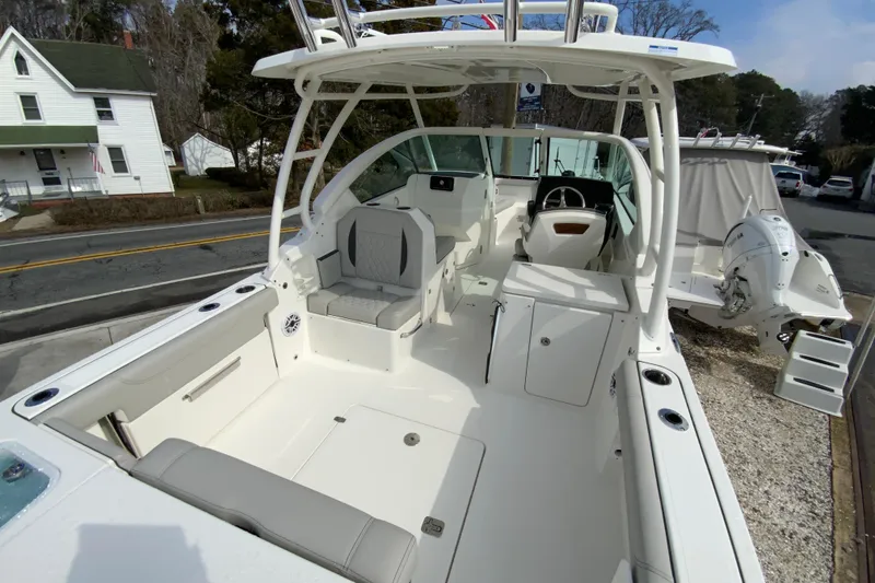 Slide: The Image of 2026 Pursuit DC 266 Dual Console boat interior with seating and steering wheel. - 4