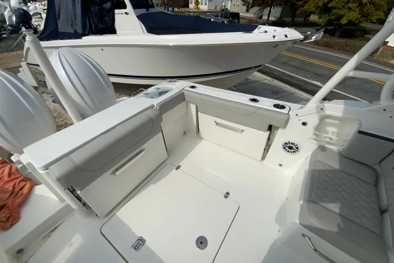 Slide: The Image of 2026 Pursuit DC 266 Dual Console boat interior with seating and storage compartments. - 5