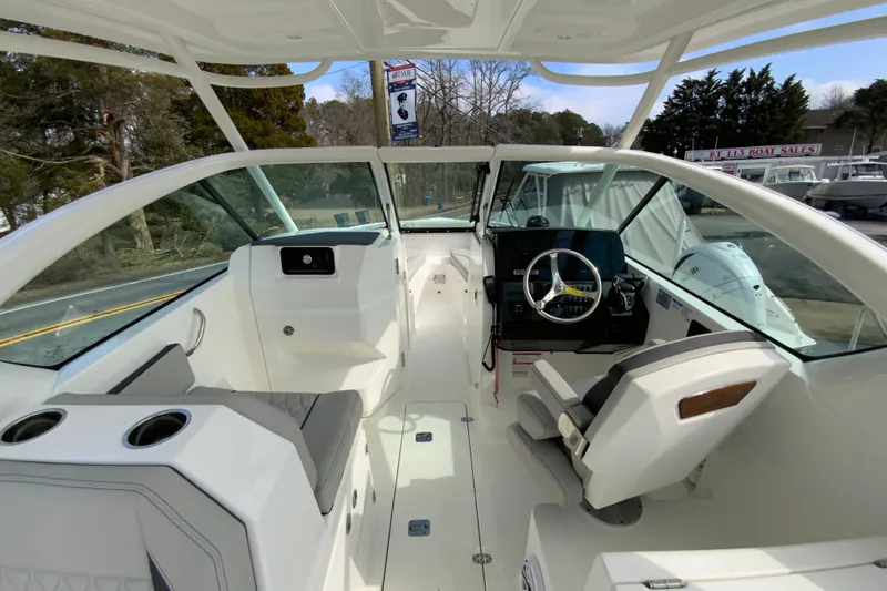 Slide: The Image of 2026 Pursuit DC 266 Dual Console boat interior with modern helm and seating. - 8