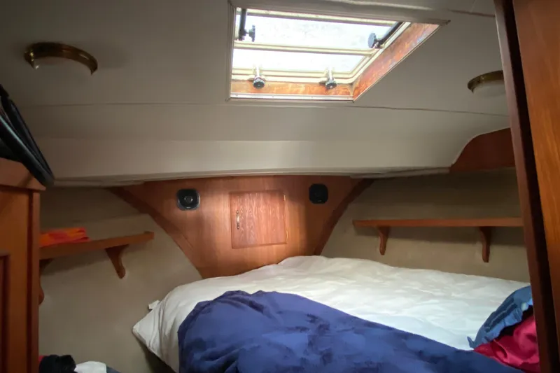 Slide: The Image of 1986 Tollycraft Flybridge Convertible cabin interior with bed and skylight. - 11