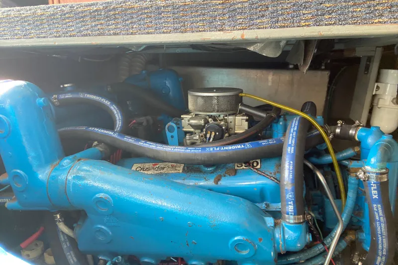 Slide: The Image of 1986 Tollycraft Flybridge Convertible engine with blue hoses and components. - 15