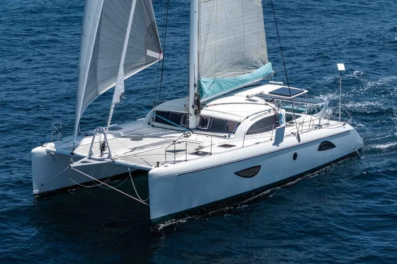 The Image of 2012 Outremer 49 catamaran sailing on open sea with full sails. - 0