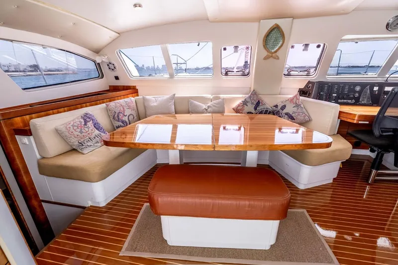 Slide: The Image of Luxurious interior of 2012 Outremer 49 yacht with elegant seating and wooden table. - 13