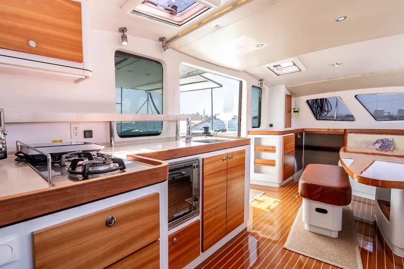 Slide: The Image of Luxurious interior of 2012 Outremer 49 yacht with modern kitchen and dining area. - 17