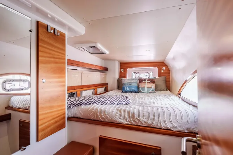 Slide: The Image of Cozy cabin interior of 2012 Outremer 49 yacht with comfortable bedding and wooden accents. - 18