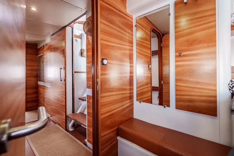 Slide: The Image of Interior of 2012 Outremer 49 yacht with wooden finishes and mirrors. - 19