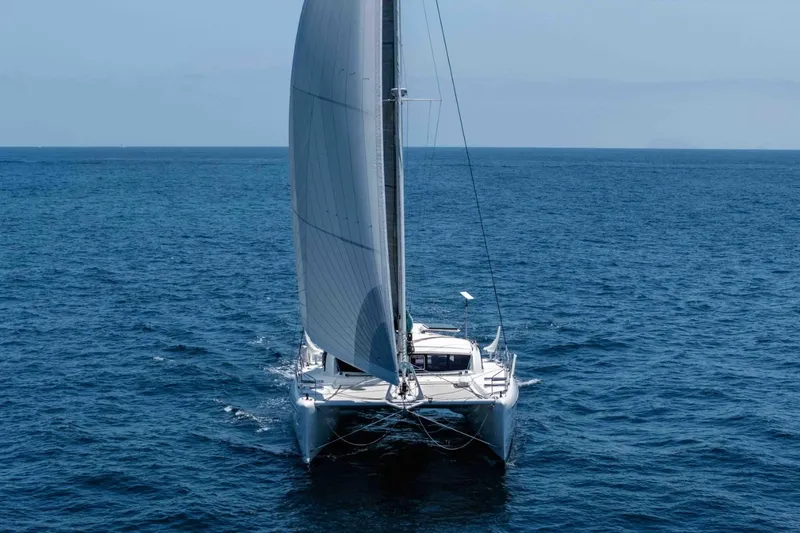 Slide: The Image of Sailing catamaran Outremer 49, 2012 model, gliding on open sea. - 2