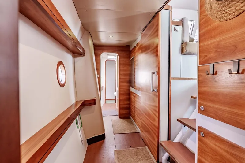 Slide: The Image of Interior of 2012 Outremer 49 yacht, featuring wooden finishes and modern design elements. - 20