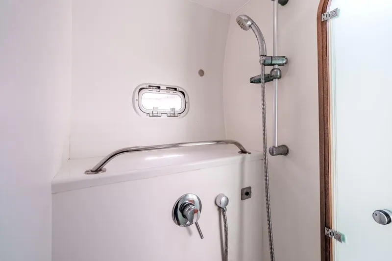 Slide: The Image of Shower area in 2012 Outremer 49 yacht, featuring modern fixtures and a small window. - 22