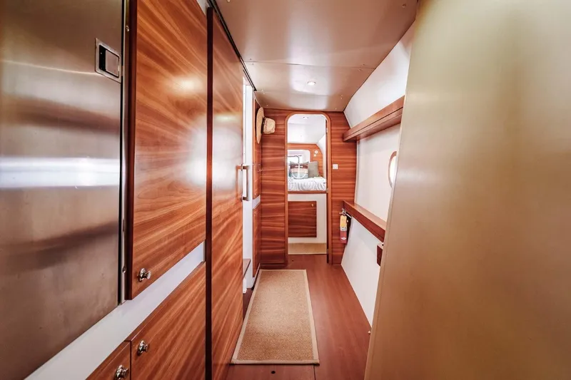 Slide: The Image of Interior of 2012 Outremer 49 yacht with wood paneling and cozy cabin view. - 24
