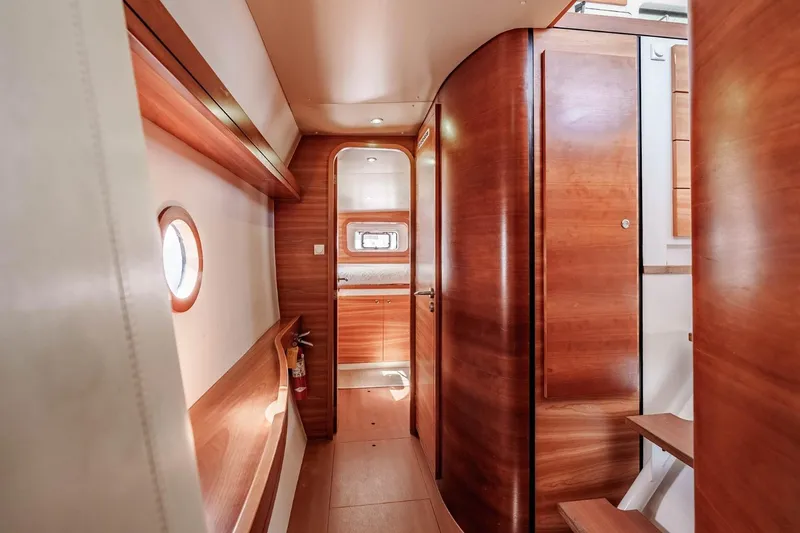 Slide: The Image of Interior of 2012 Outremer 49 yacht with wooden finishes and porthole window. - 25