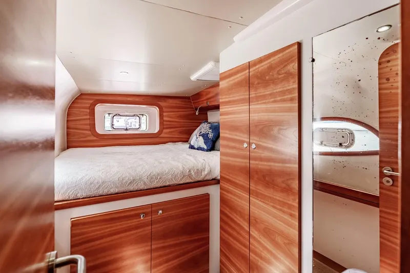 Slide: The Image of Luxurious cabin interior of 2012 Outremer 49 yacht with wood finish and cozy bed. - 26
