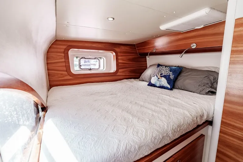 Slide: The Image of Cozy cabin interior of 2012 Outremer 49 yacht with wood accents and comfortable bedding. - 27