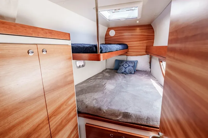 Slide: The Image of Cozy cabin interior of 2012 Outremer 49 yacht with wooden finishes and bedding. - 30