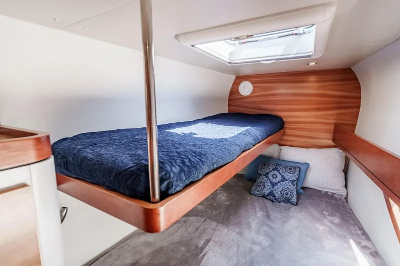 Slide: The Image of Cozy cabin interior of 2012 Outremer 49 yacht with wooden accents and bedding. - 31