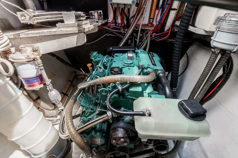 Slide: The Image of Engine compartment of a 2012 Outremer 49 sailboat, showcasing detailed mechanical components. - 36