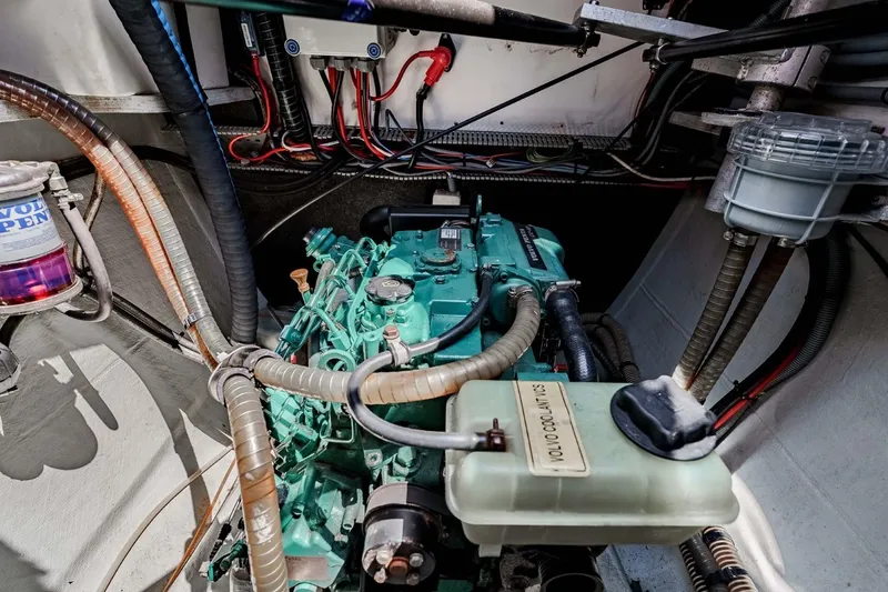 Slide: The Image of Engine compartment of a 2012 Outremer 49 sailboat, featuring Volvo components and wiring. - 37