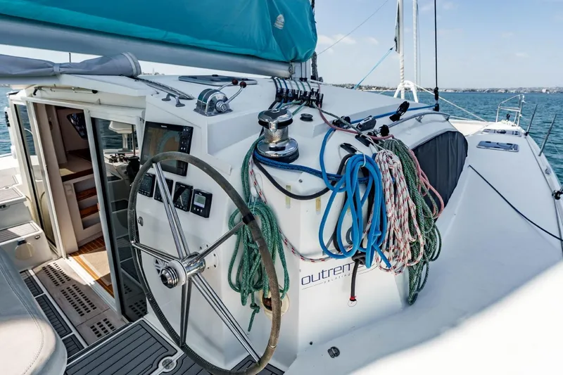 Slide: The Image of 2012 Outremer 49 yacht cockpit with steering wheel, ropes, and navigation equipment. - 4