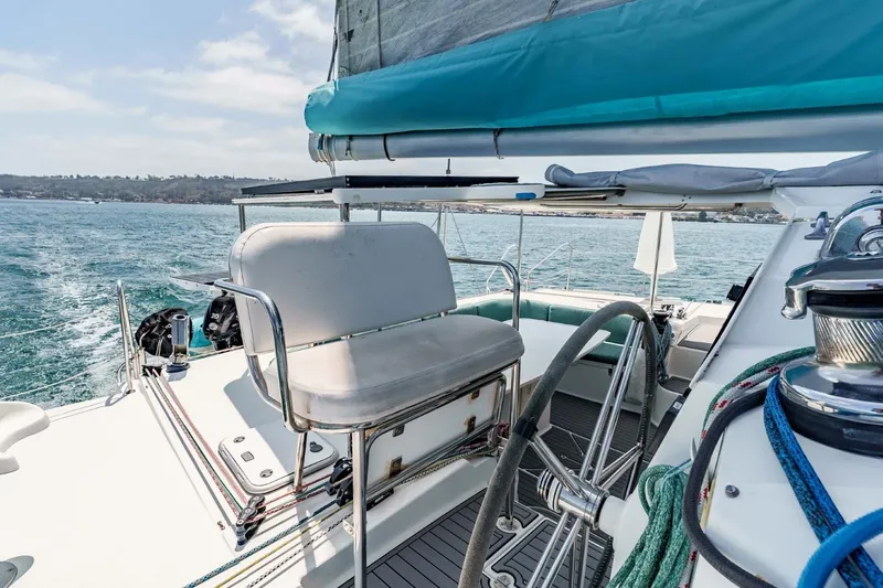Slide: The Image of 2012 Outremer 49 sailboat cockpit with steering wheel and seating, cruising on open water. - 8