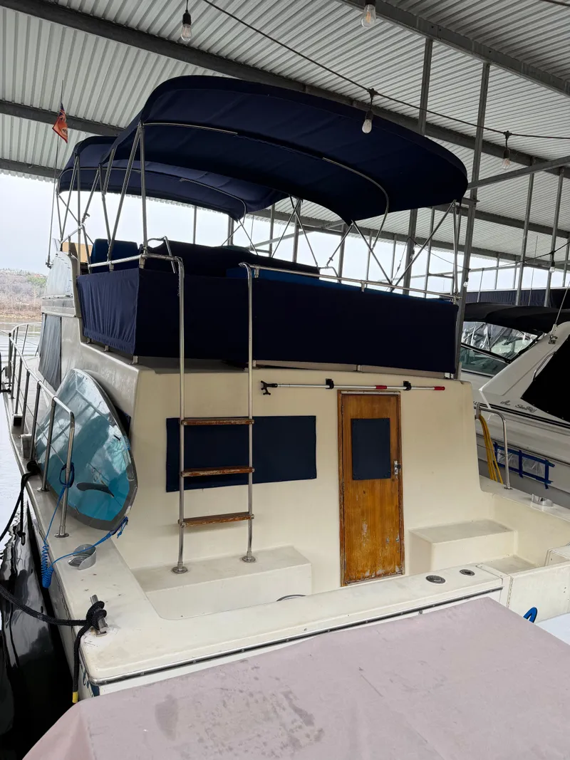 Slide: The Image of 1980 Chris-Craft Corinthian yacht docked in marina. - 2