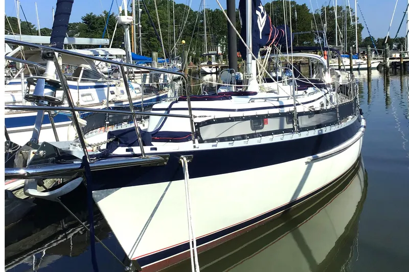 The Image of 2010 Valiant 42 CE/SE sailboat docked in a marina, surrounded by other boats. - 0