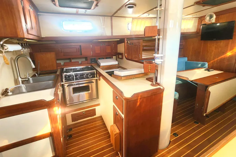Slide: The Image of Interior of 2010 Valiant 42 CE/SE yacht with wooden cabinetry and navigation station. - 12