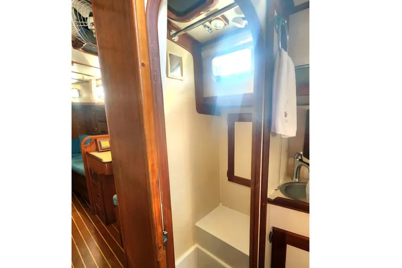 Slide: The Image of Cozy interior of 2010 Valiant 42 CE/SE yacht with blue seating and wooden accents. - 14