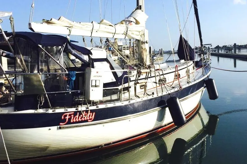 Slide: The Image of Sailboat "Fidelity" docked, Valiant 42 CE/SE, 2010 model, in calm marina waters. - 2