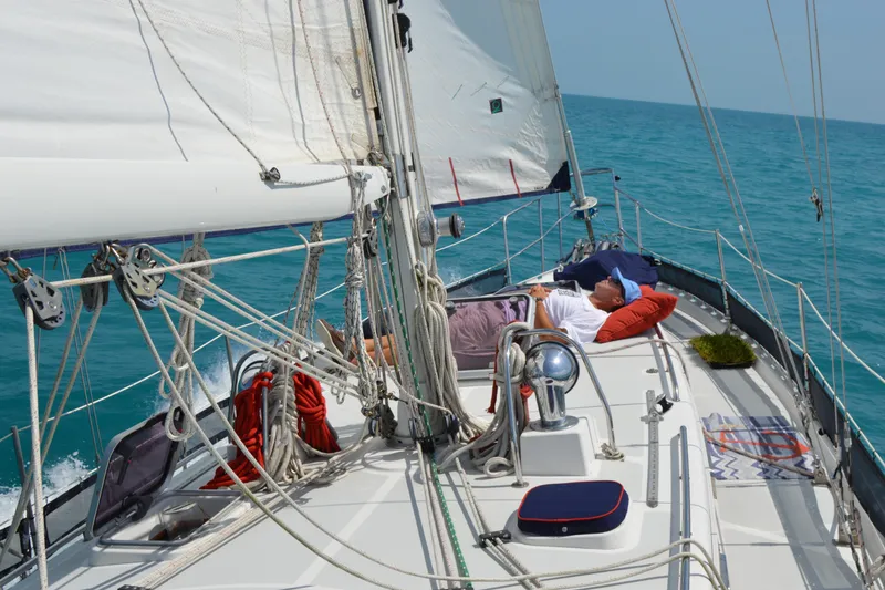 Slide: The Image of Valiant 42 CE/SE 2010 sailboat deck with blue cushions and docked at marina. - 3