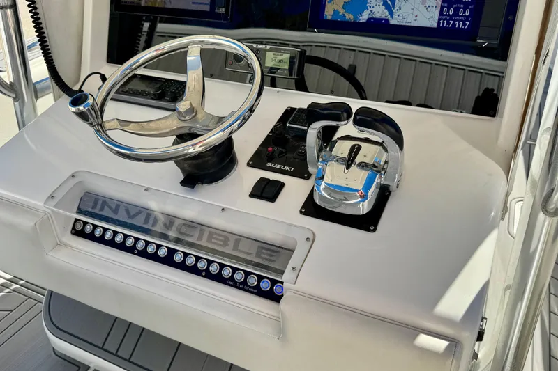 Slide: The Image of Control panel of a 2014 Invincible 36 Open Fisherman boat with steering wheel and throttle. - 10