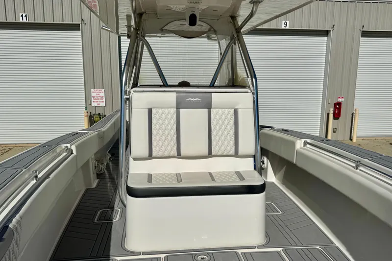 Slide: The Image of 2014 Invincible 36 Open Fisherman boat interior with cushioned seating and storage compartments. - 13