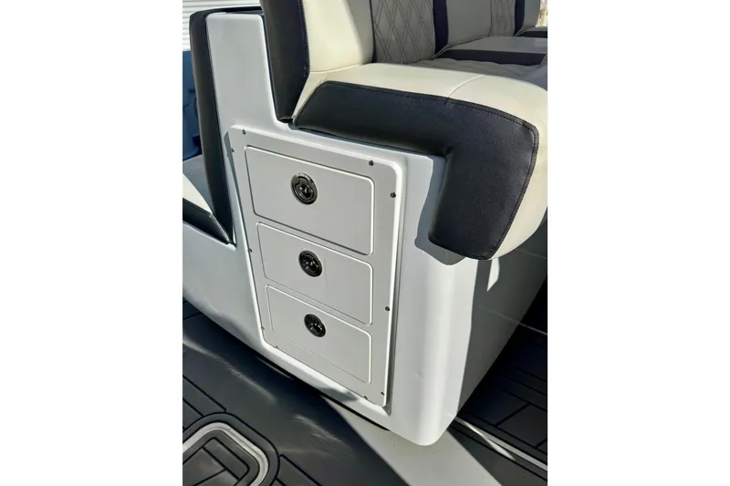 Slide: The Image of 2014 Invincible 36 Open Fisherman boat interior with storage drawers and cushioned seating. - 18