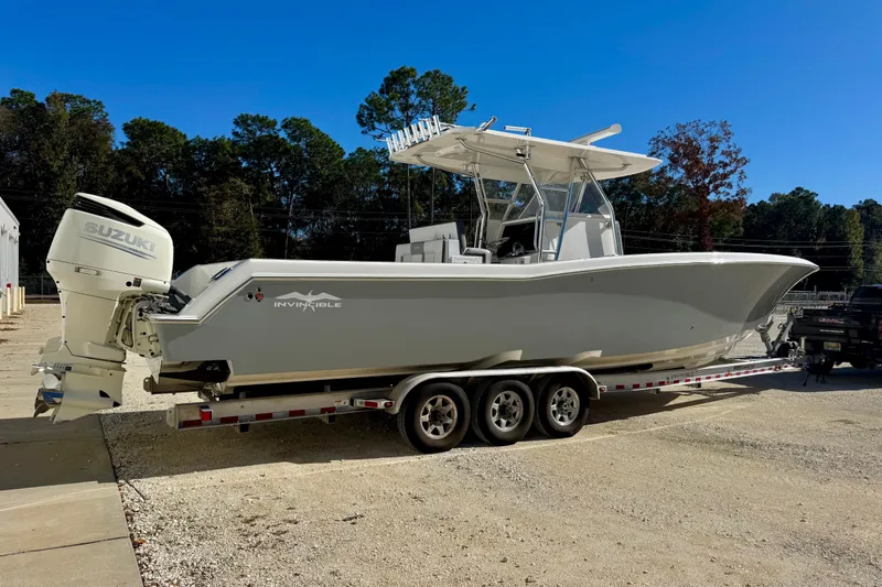 Slide: The Image of 2014 Invincible 36 Open Fisherman boat on trailer with Suzuki outboard motor. - 3