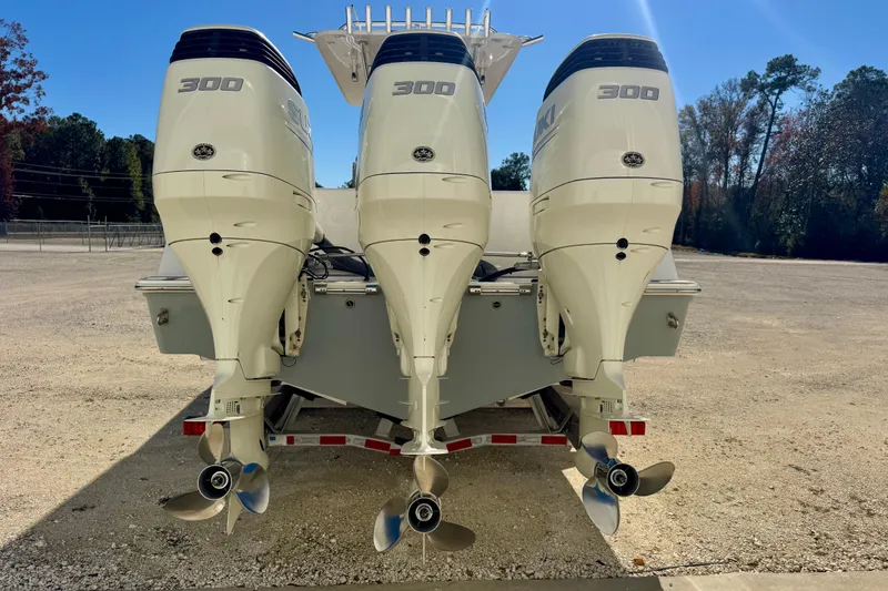 Slide: The Image of Triple 300 horsepower engines on a 2014 Invincible 36 Open Fisherman boat. - 5