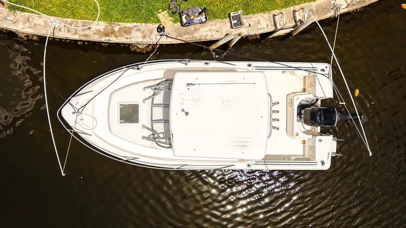 Slide: The Image of Overhead view of a 1999 Pro-Line 201 Walkaround boat docked by a canal. - 5
