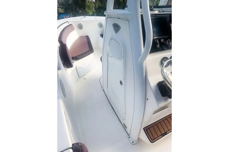 Slide: The Image of 2017 Tidewater 230 CC Adventure boat interior with seating and console. - 9