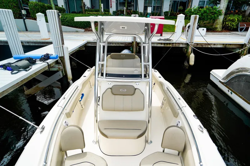 Slide: The Image of 2022 Key West 219 FS boat docked, featuring spacious seating and sleek design. - 20