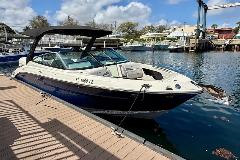 Slide: The Image of 2025 Sea Ray SLX 280 Outboard boat docked at marina under blue sky. - 10