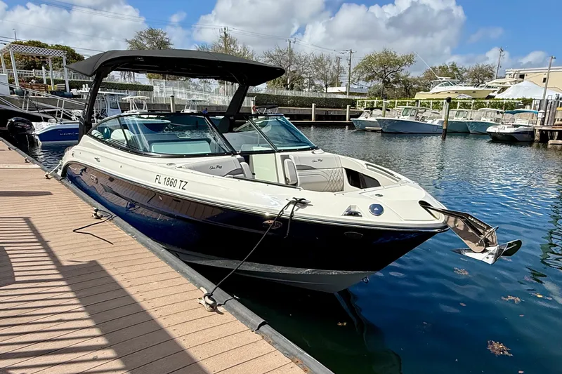 Slide: The Image of 2025 Sea Ray SLX 280 Outboard docked at marina under clear skies. - 11