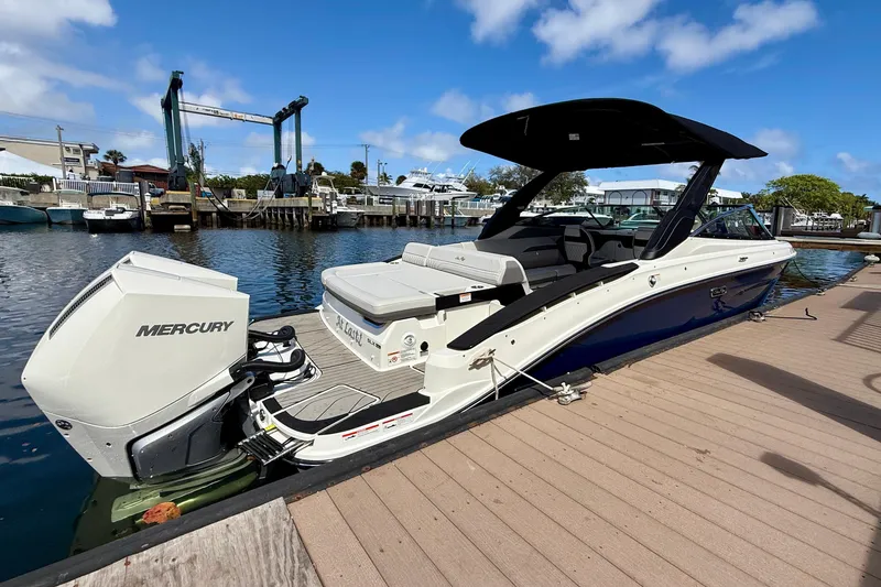 Slide: The Image of 2025 Sea Ray SLX 280 Outboard at dock, sunny day. - 13