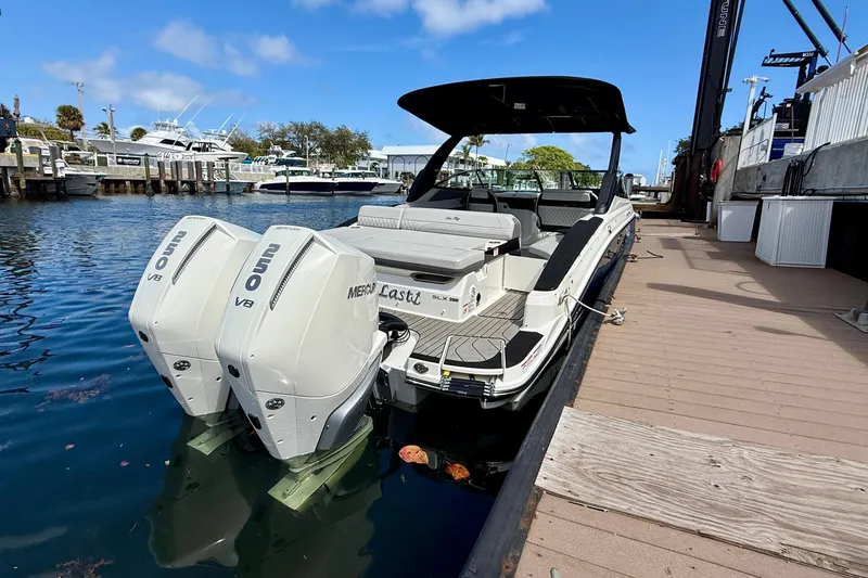 Slide: The Image of 2025 Sea Ray SLX 280 Outboard at dock, featuring dual outboard engines. - 14