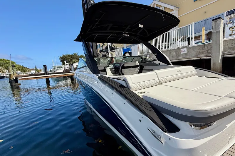 Slide: The Image of 2025 Sea Ray SLX 280 Outboard boat docked in a marina, showcasing sleek design. - 18