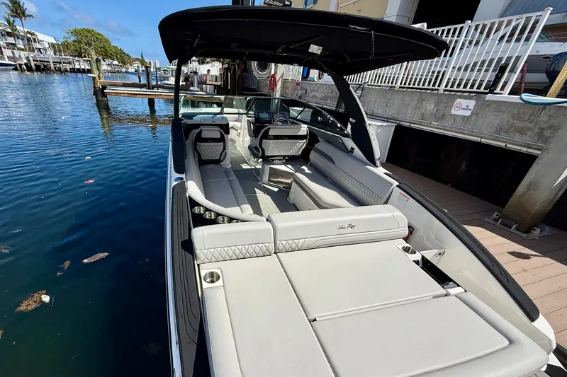 Slide: The Image of 2025 Sea Ray SLX 280 Outboard luxury boat docked by the water. - 20