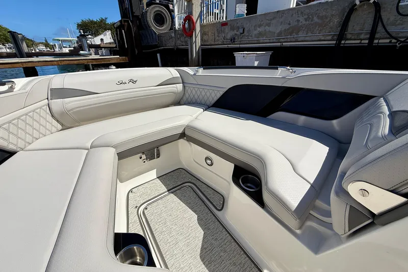 Slide: The Image of 2025 Sea Ray SLX 280 Outboard interior with luxurious white seating and cup holders. - 27