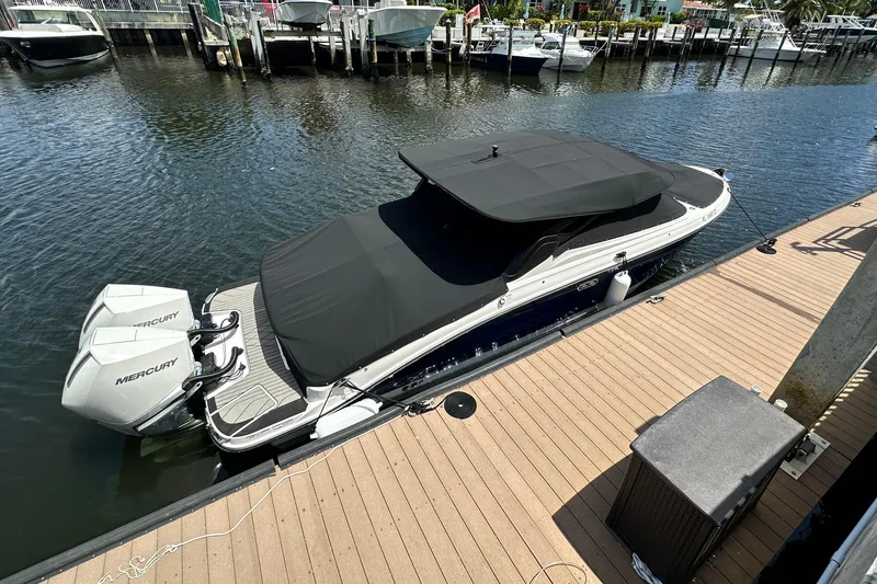 Slide: The Image of 2025 Sea Ray SLX 280 Outboard cruising on blue water, rear view. - 3