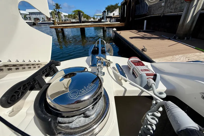 Slide: The Image of 2025 Sea Ray SLX 280 Outboard boat docked, featuring a Quick anchor system. - 33