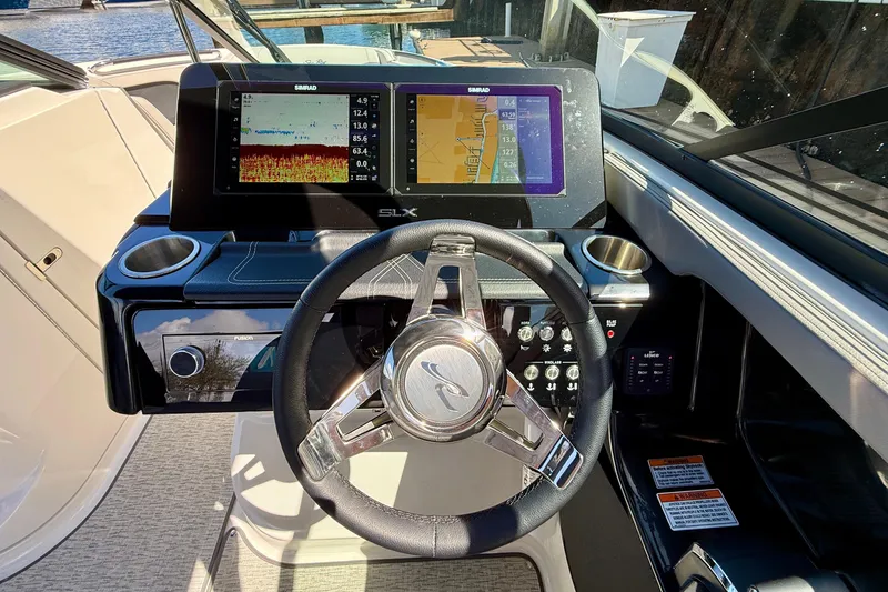 Slide: The Image of 2025 Sea Ray SLX 280 Outboard helm with modern displays. - 35