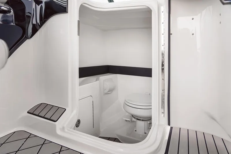 Slide: The Image of 2025 Sea Ray SLX 280 Outboard cruising on a sunny waterfront near a marina. - 4