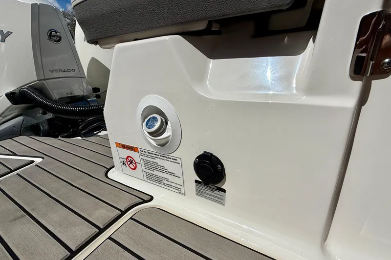 Slide: The Image of 2025 Sea Ray SLX 280 Outboard boat detail with engine and warning labels. - 48