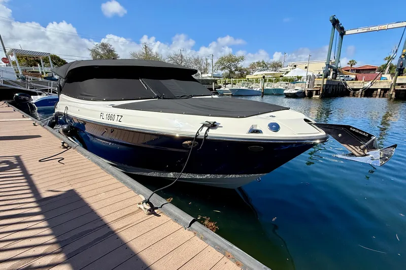 Slide: The Image of 2025 Sea Ray SLX 280 Outboard boat docked with cover, calm water, sunny day. - 57